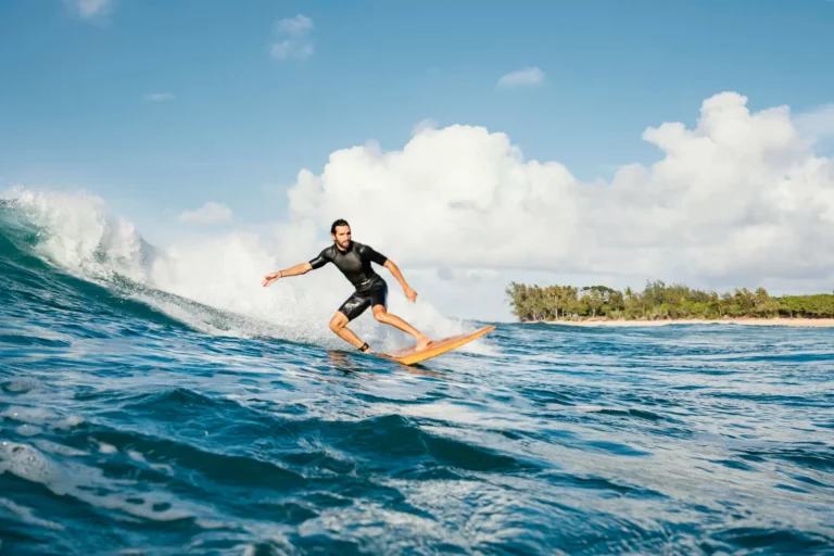 Young man surfing in clear ocean waves